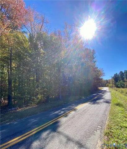 a view of a yard with wooden fence