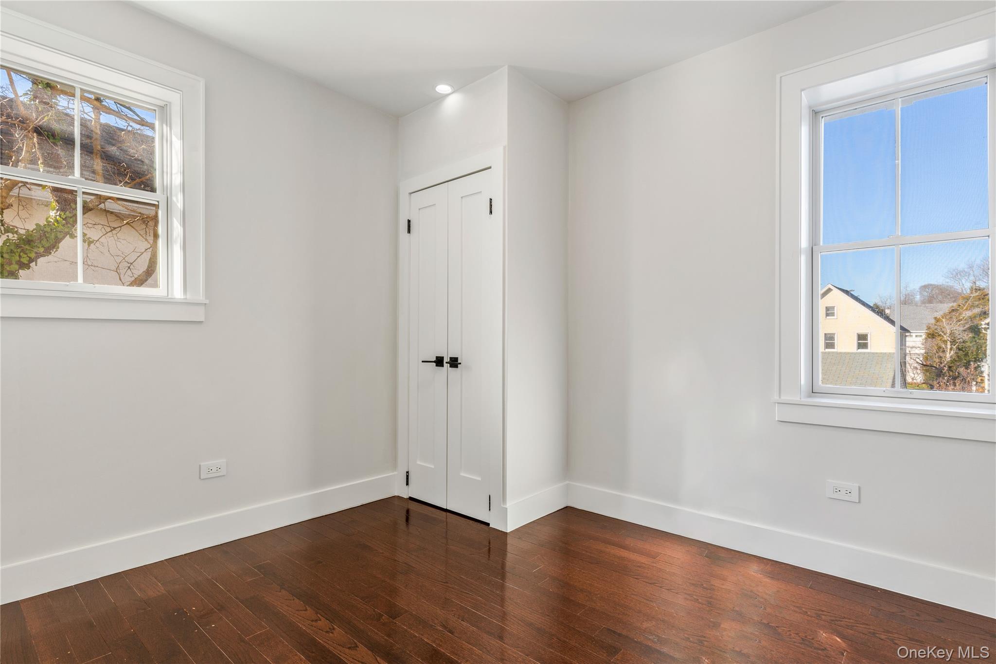 385 Midland Avenue, Unit 2 Rye, NY 10580 - Photo 11 of 20 an empty room with wooden floor and windows