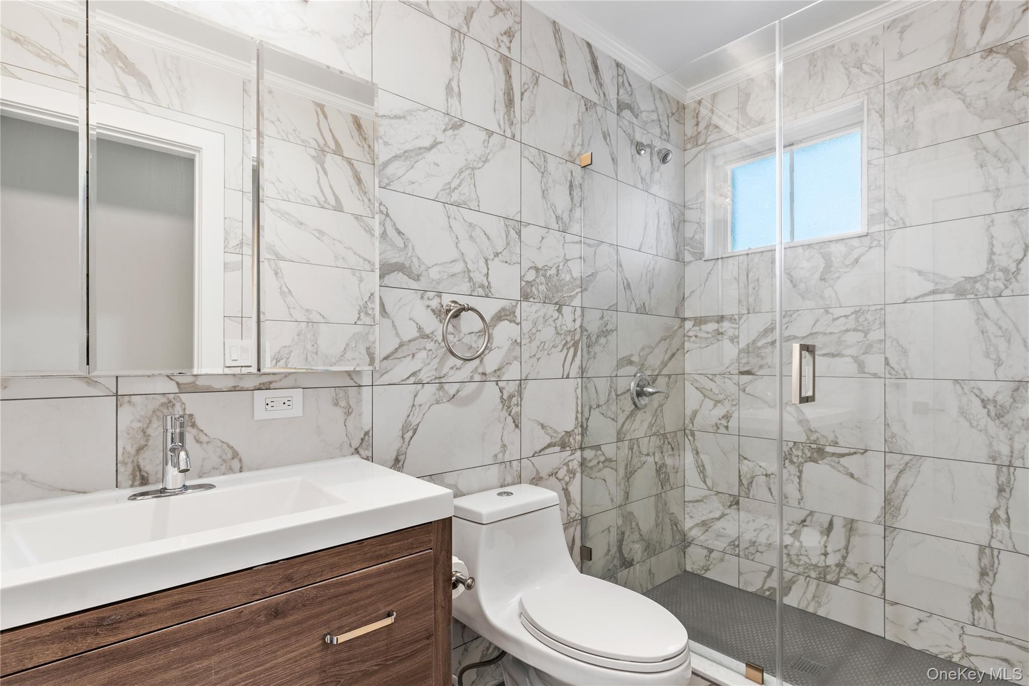 385 Midland Avenue, Unit 2 Rye, NY 10580 - Photo 12 of 20 a bathroom with a sink a toilet and shower