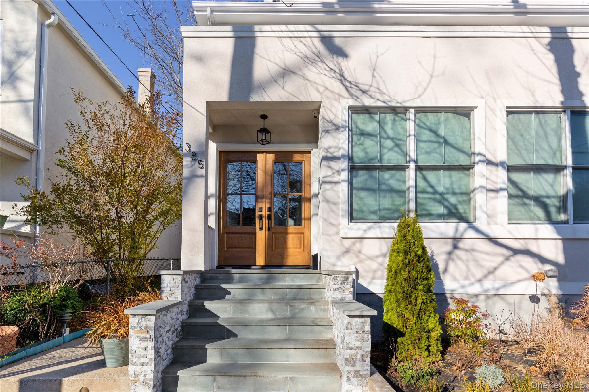 385 Midland Avenue, Unit 2 Rye, NY 10580 - Photo 19 of 20 a front view of a house with a garden
