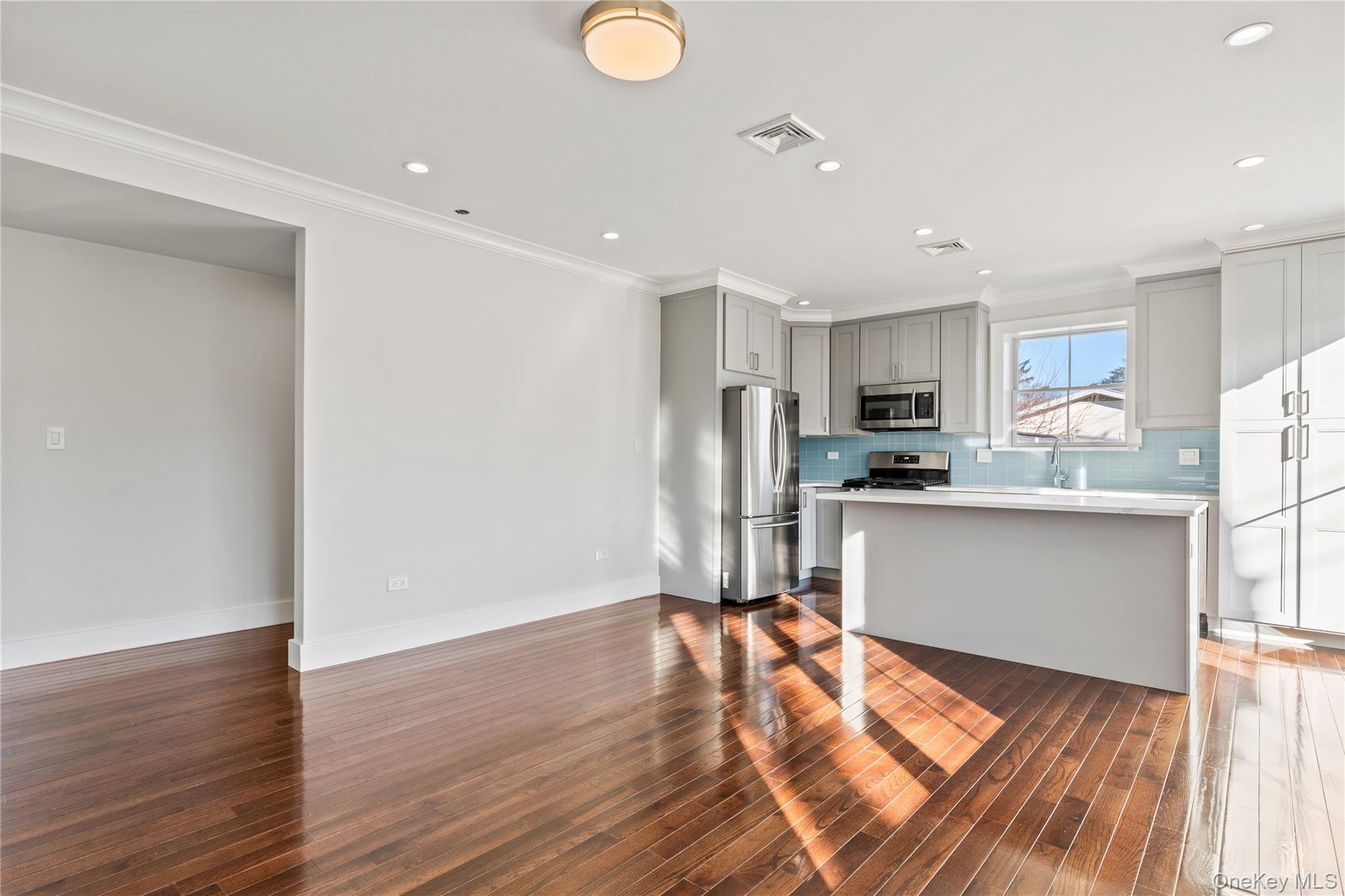 385 Midland Avenue, Unit 2 Rye, NY 10580 - Photo 3 of 20 a kitchen with stainless steel appliances granite countertop a refrigerator sink and white cabinets
