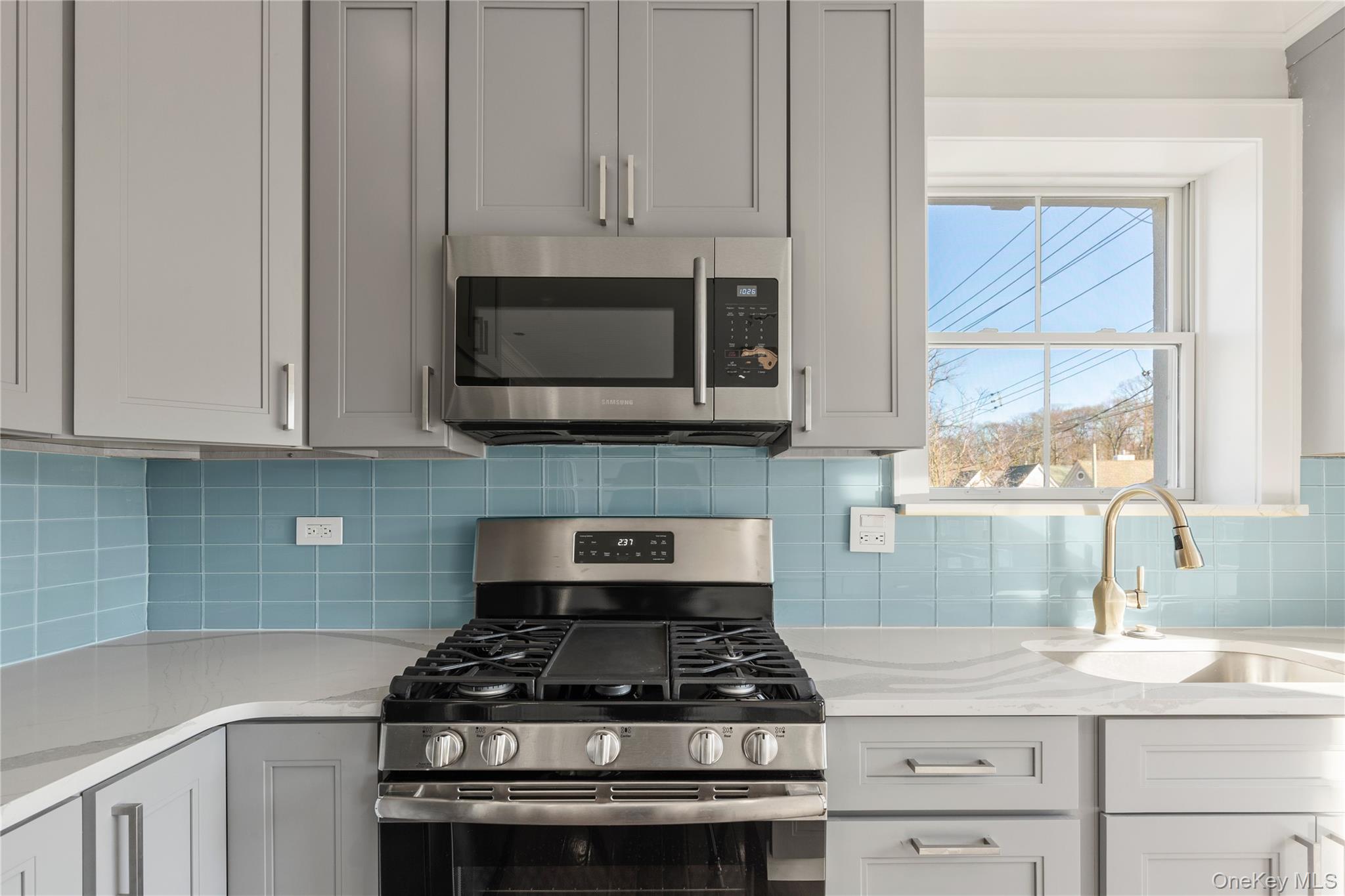 385 Midland Avenue, Unit 2 Rye, NY 10580 - Photo 7 of 20 a kitchen with stainless steel appliances granite countertop white cabinets a stove top oven and granite counter tops