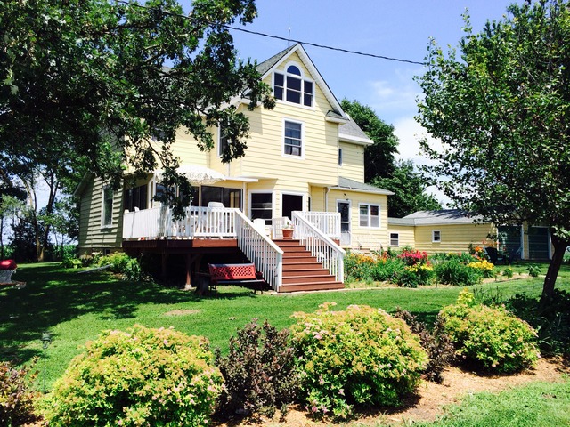4766 Graham Road Somonauk, IL 60552 - Photo 1 of 25 a front view of a house with a yard and potted plants