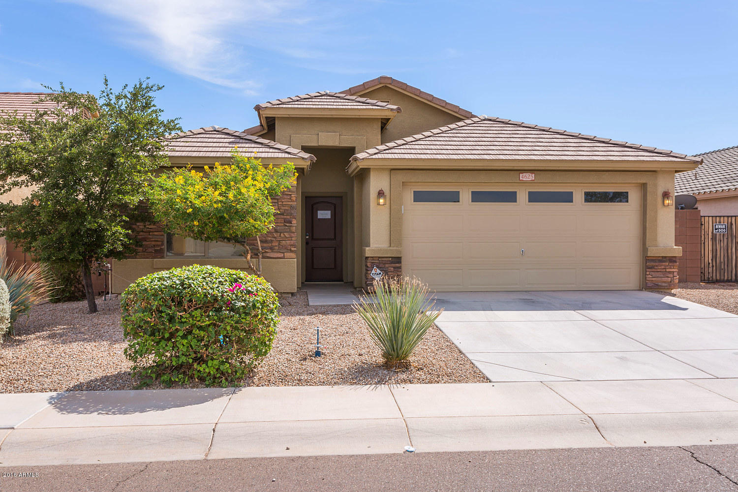 4625 West Carson Road Laveen, AZ 85339 - Photo 1 of 19 a front view of a house with garden
