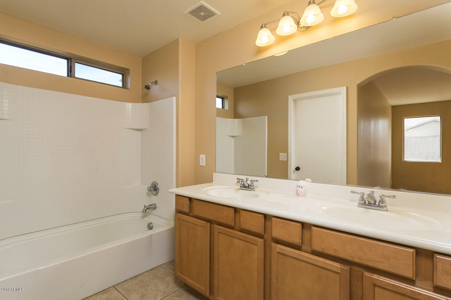 4625 West Carson Road Laveen, AZ 85339 - Photo 11 of 19 a bathroom with a tub double sink and mirror