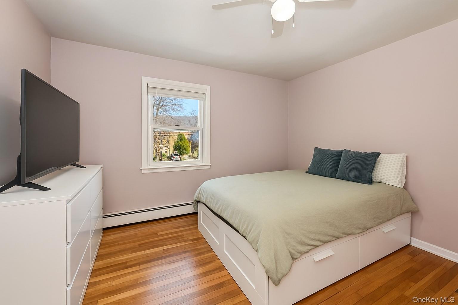 568 Manville Road, Unit UPPER R Pleasantville, NY 10570 - Photo 24 of 32 Hardwood flooring and a single window with white trim. There is another window on the left not seen in the photo.
