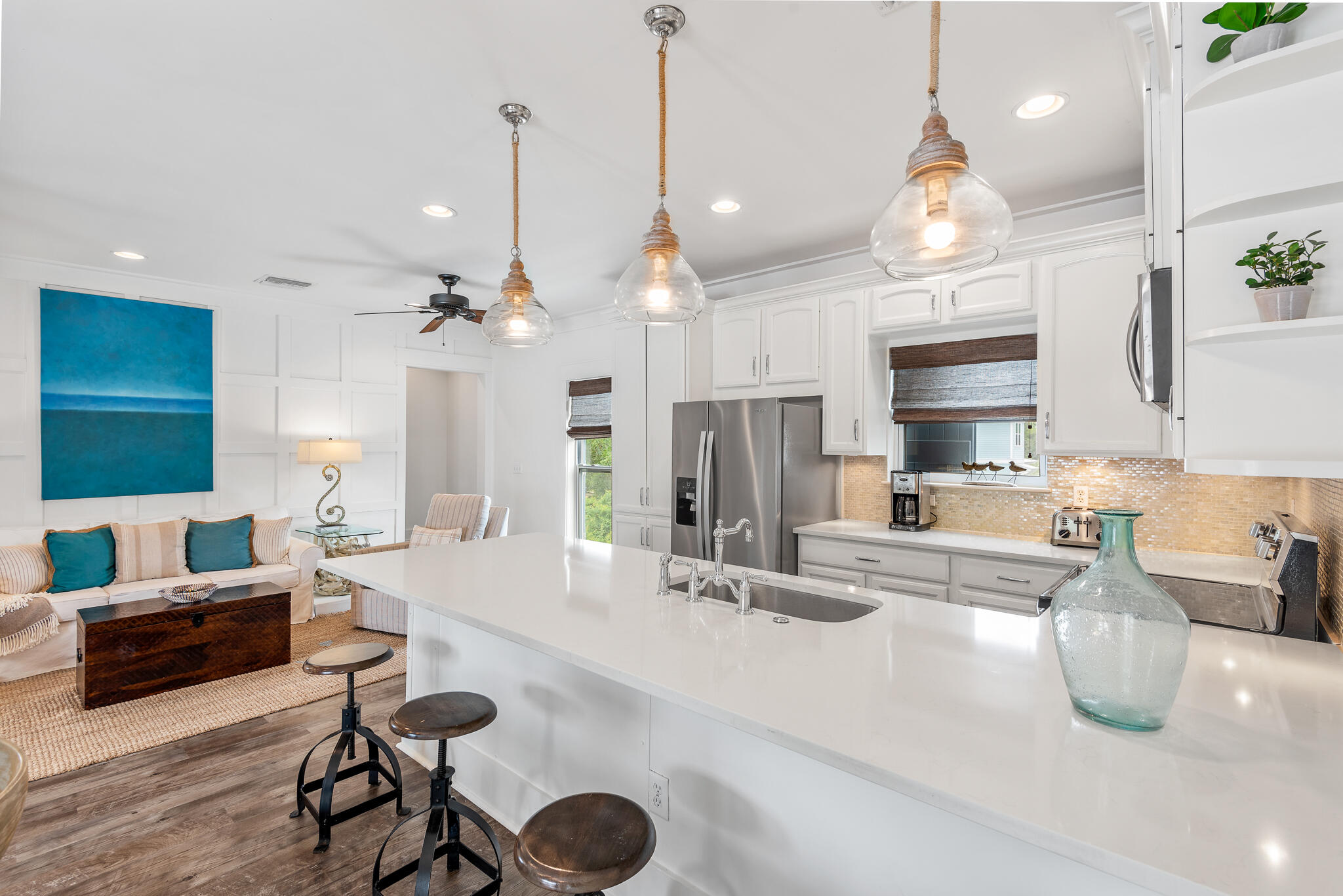 139 Brown Street Santa Rosa Beach, FL 32459 - Photo 16 of 45 a large kitchen with kitchen island a stove a sink a dining table and chairs