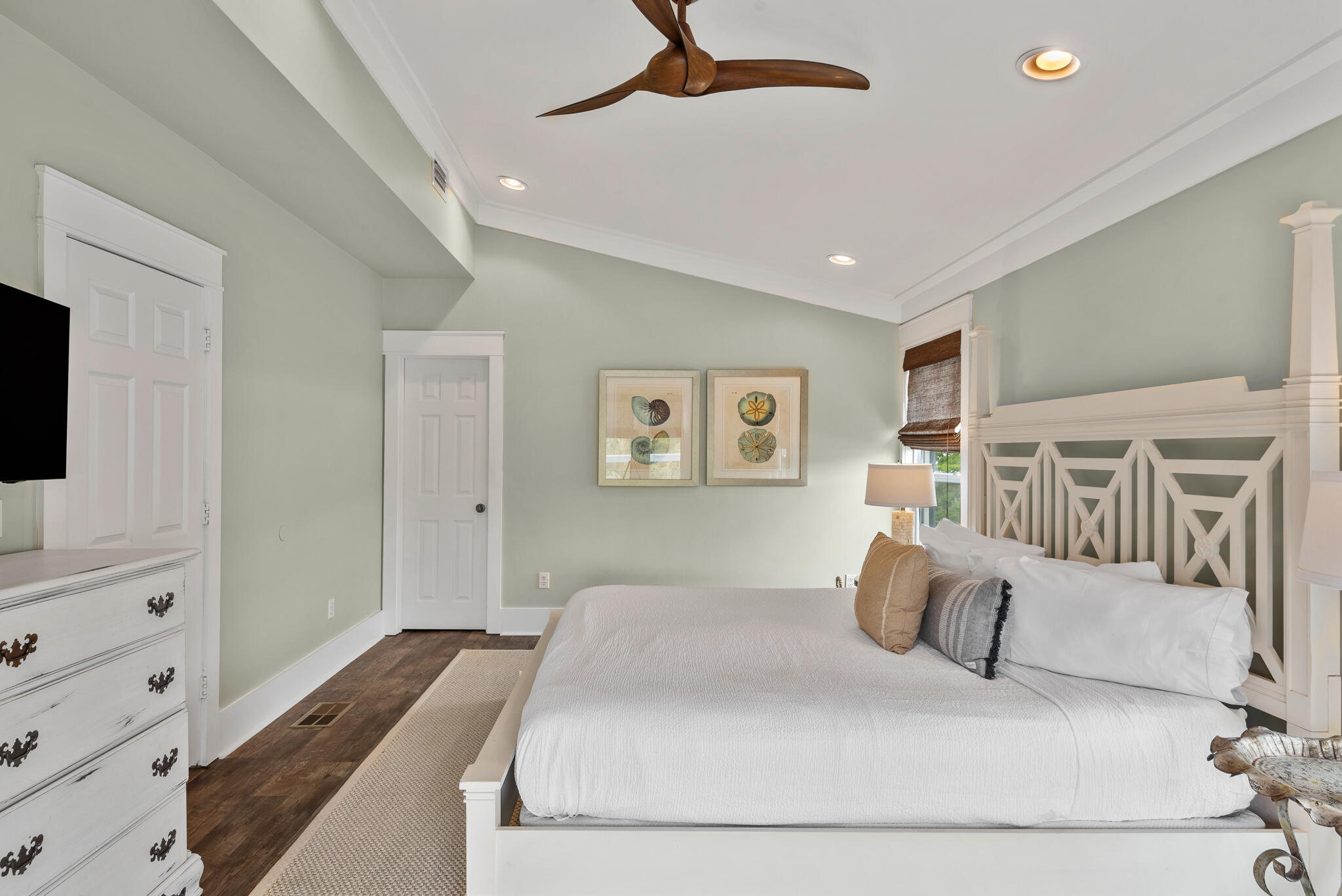 139 Brown Street Santa Rosa Beach, FL 32459 - Photo 30 of 45 a bedroom with a large bed and a flat tv screen on dresser