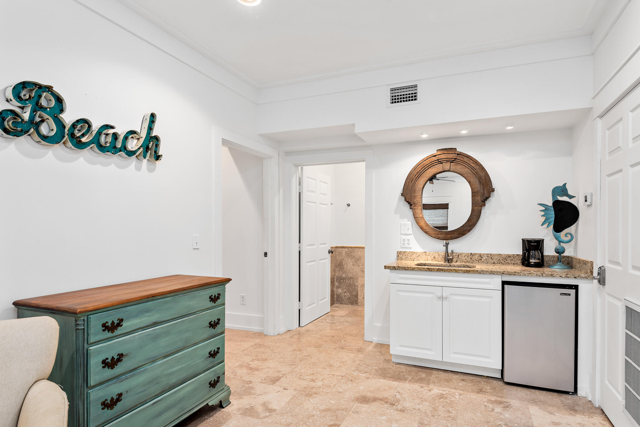 139 Brown Street Santa Rosa Beach, FL 32459 - Photo 32 of 45 a room with painting on the wall and a dresser