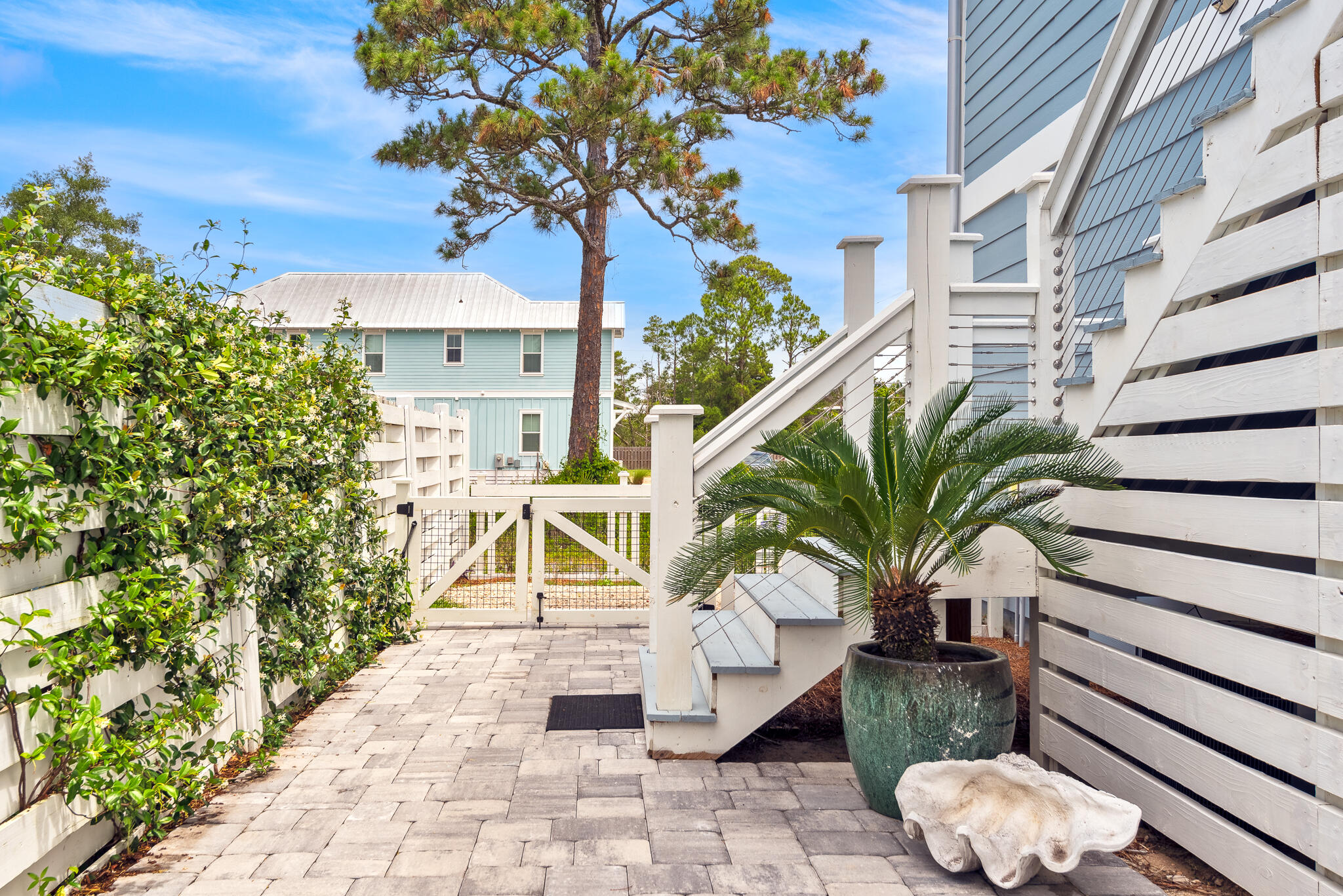139 Brown Street Santa Rosa Beach, FL 32459 - Photo 40 of 45 a potted plant sitting in front of a building
