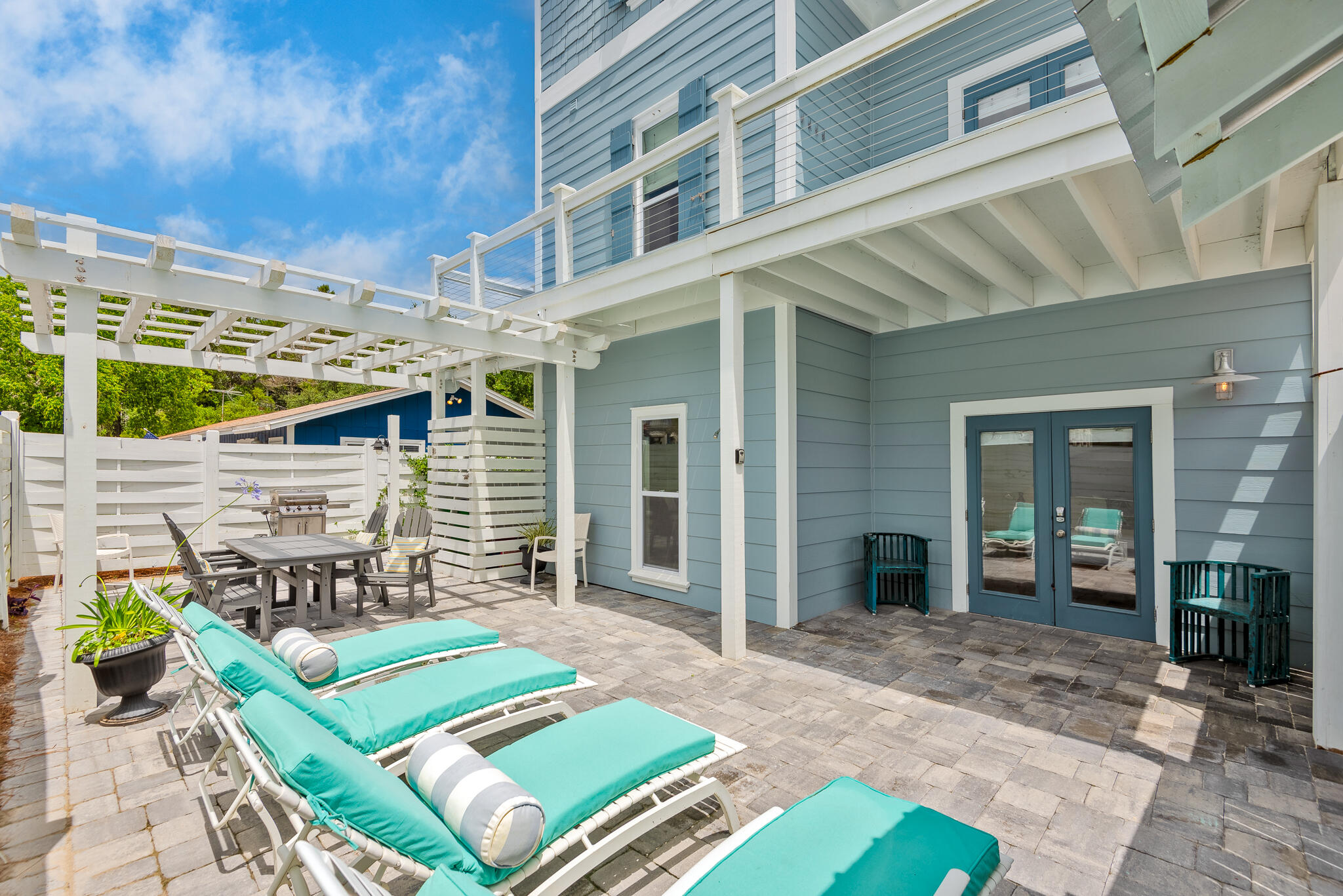 139 Brown Street Santa Rosa Beach, FL 32459 - Photo 6 of 45 a view of a patio with table and chairs with wooden floor and fence