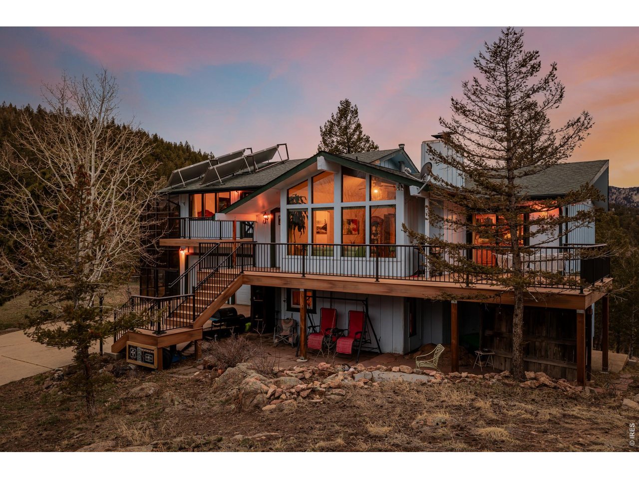 37 High View Lane Boulder, CO 80302 - Photo 4 of 50 a view of a house with a wooden deck and a forest