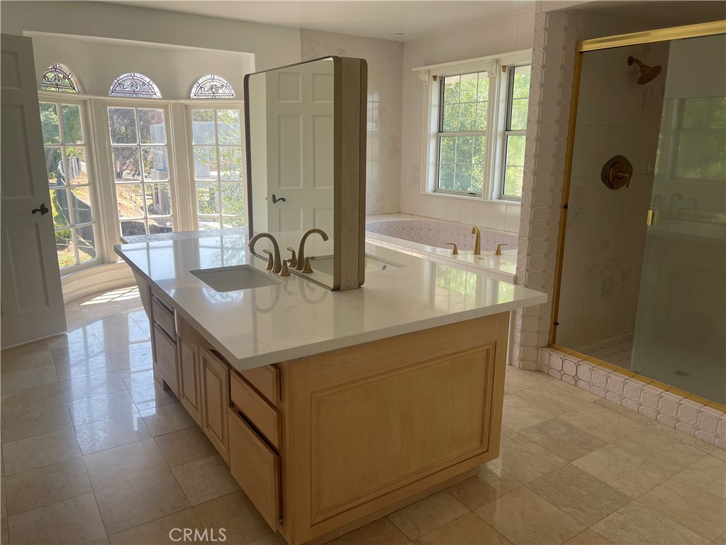 26421 Broken Bit Lane Laguna Hills, CA 92653 - Photo 12 of 15 a kitchen with stainless steel appliances granite countertop a sink and a granite counter tops with a large window