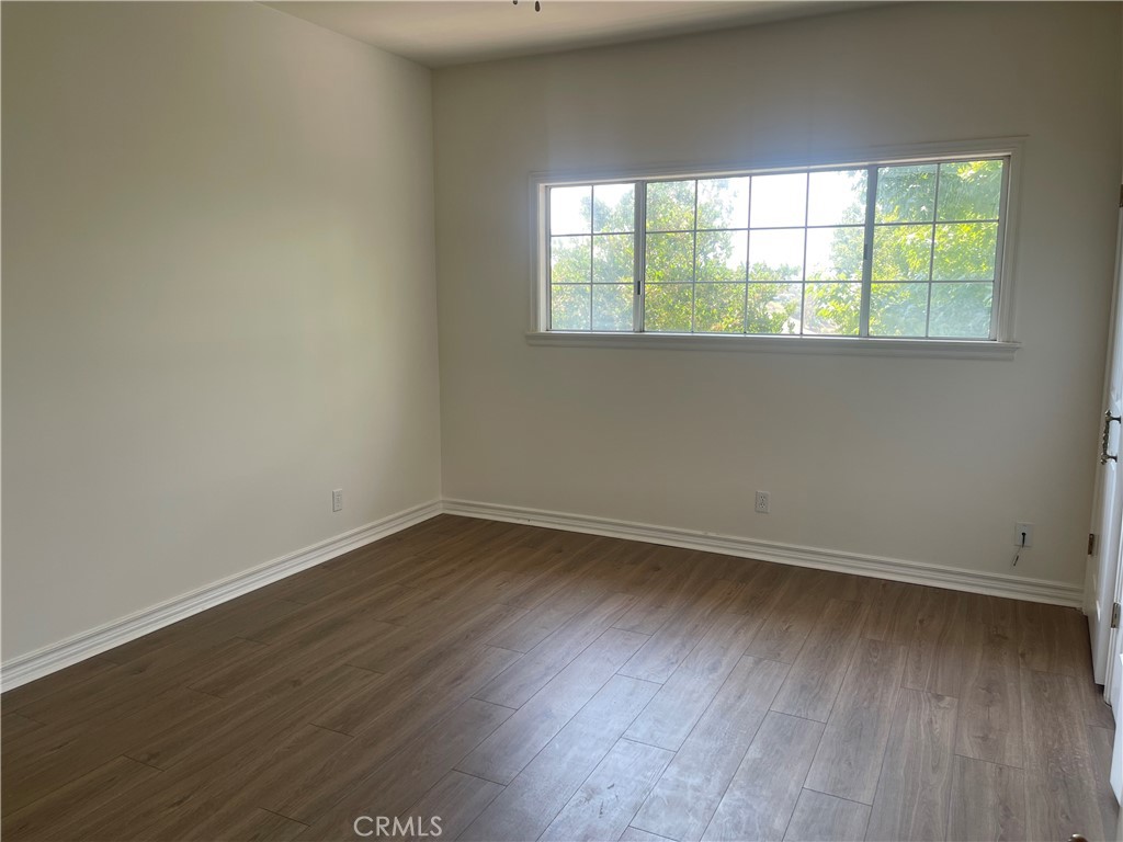 26421 Broken Bit Lane Laguna Hills, CA 92653 - Photo 14 of 15 an empty room with wooden floor and windows