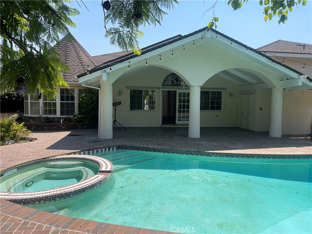 26421 Broken Bit Lane Laguna Hills, CA 92653 - Photo 3 of 15 a view of a white house with a big yard and potted plants
