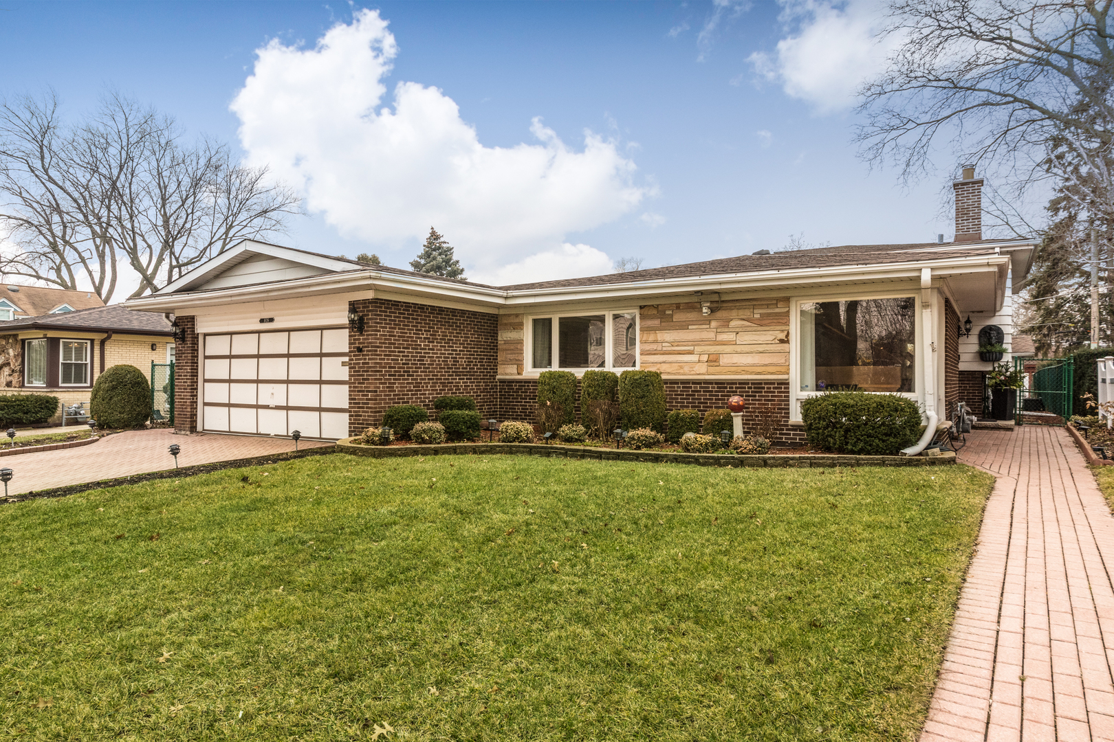 1026 Fortuna Avenue Park Ridge, IL 60068 - Photo 2 of 43 a front view of a house with a garden and yard