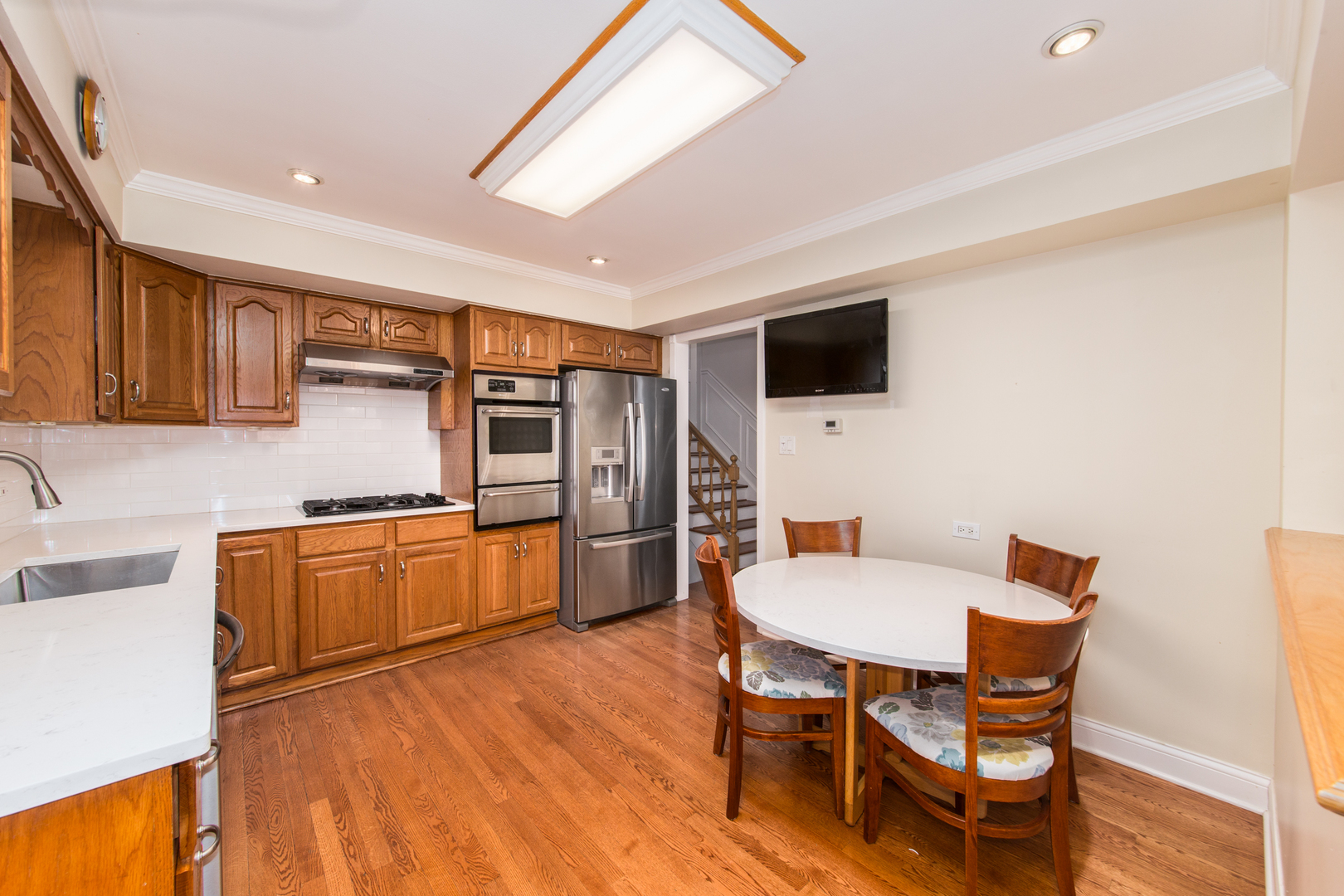1026 Fortuna Avenue Park Ridge, IL 60068 - Photo 8 of 43 a kitchen with stainless steel appliances wooden floors and wooden cabinets
