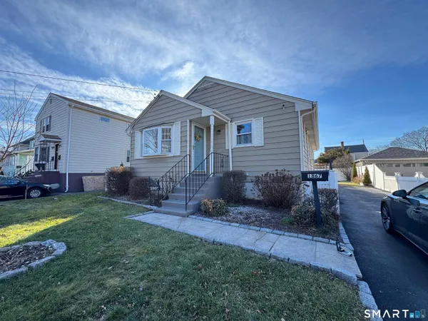 a view of a house with a yard and furniture