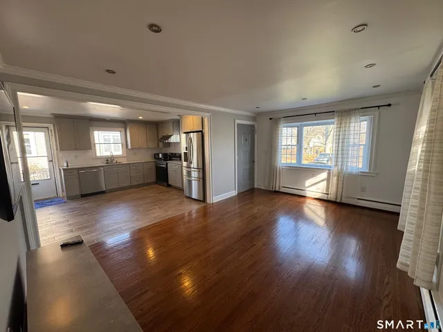 wooden floor in an empty room with a window