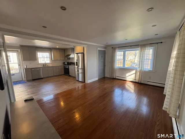 wooden floor in an empty room with a window