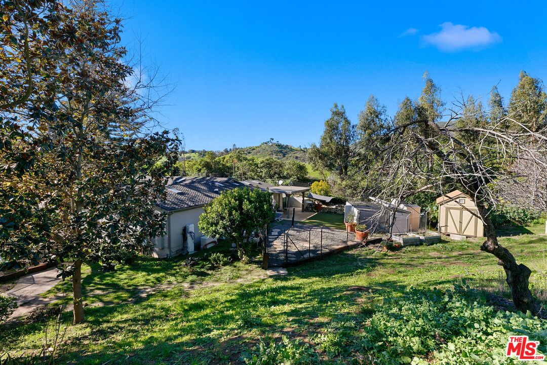 6070 Ramirez Canyon Road Malibu, CA 90265 - Photo 15 of 42 a view of a house with a yard