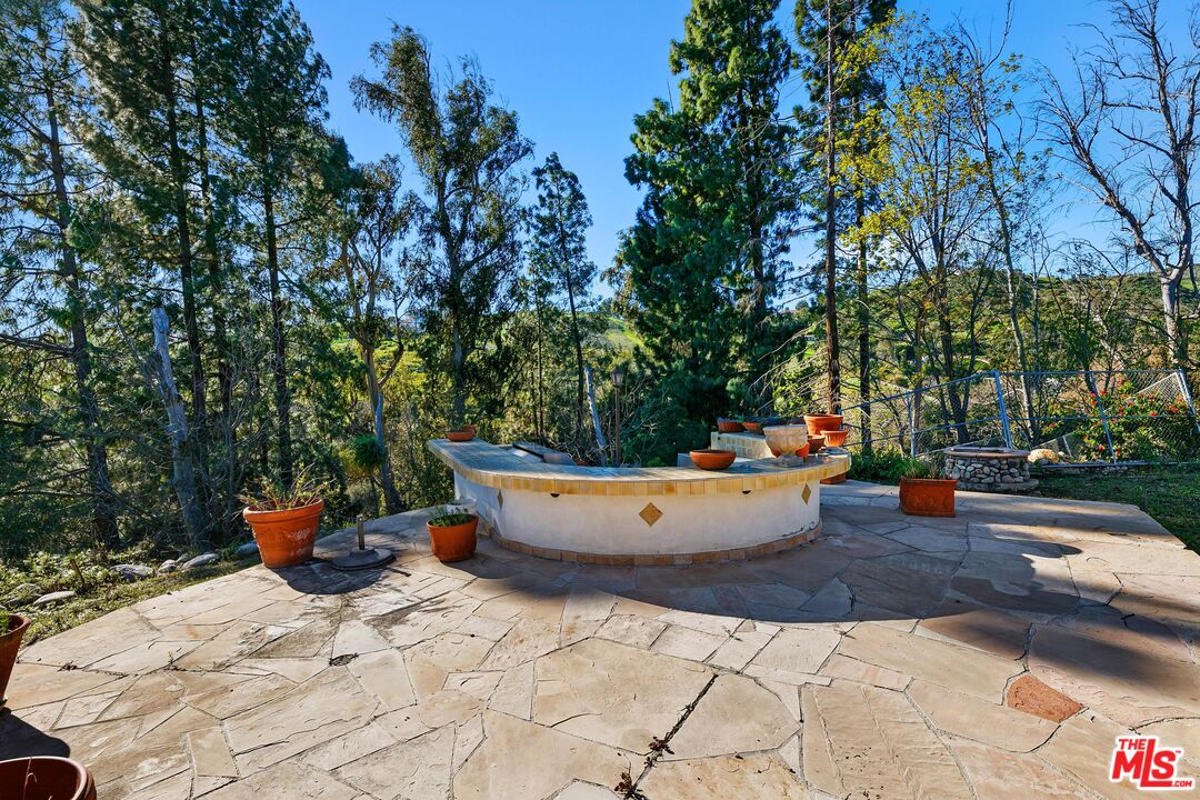 6070 Ramirez Canyon Road Malibu, CA 90265 - Photo 28 of 42 a view of a swimming pool with a patio