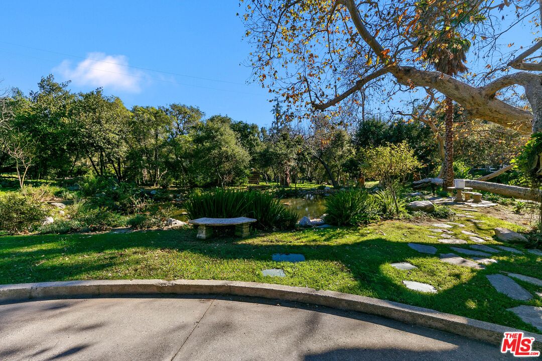 6070 Ramirez Canyon Road Malibu, CA 90265 - Photo 31 of 42 a view of a garden with a bench