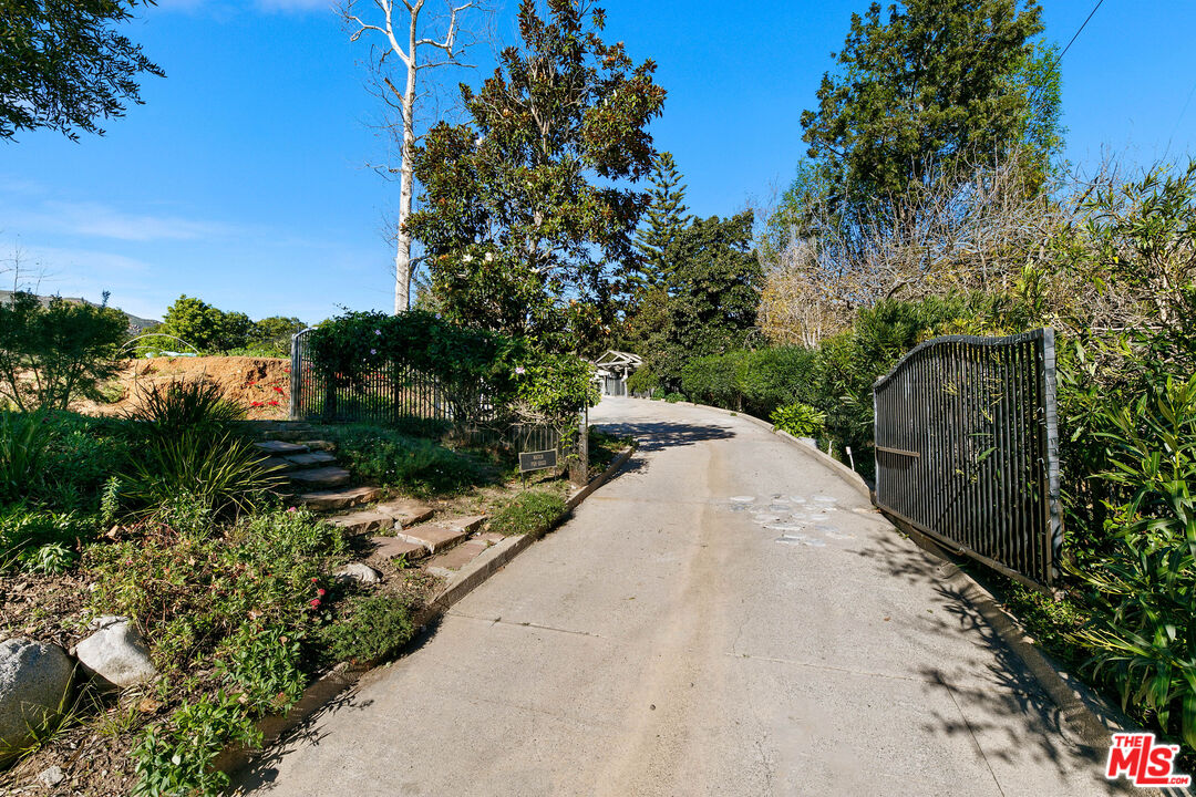 6070 Ramirez Canyon Road Malibu, CA 90265 - Photo 32 of 42 a view of a garden with a pathway