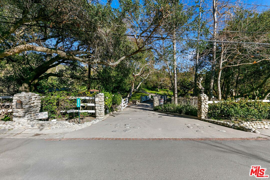 6070 Ramirez Canyon Road Malibu, CA 90265 - Photo 34 of 42 a row of palm trees sitting in a park with large trees