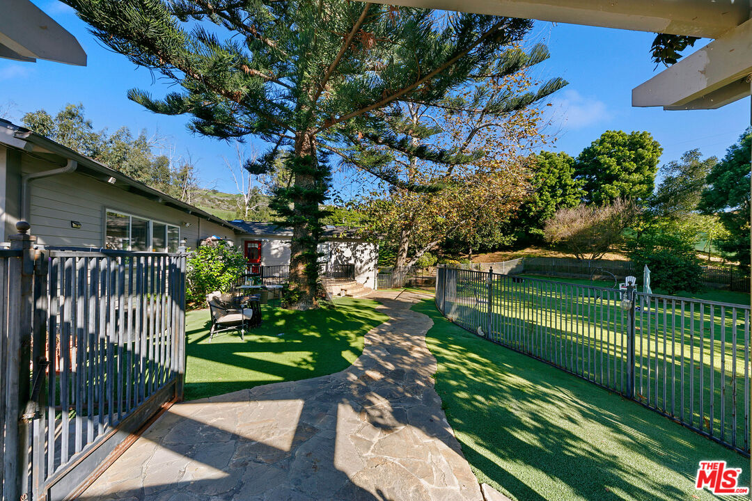 6070 Ramirez Canyon Road Malibu, CA 90265 - Photo 5 of 42 a view of a house with a yard