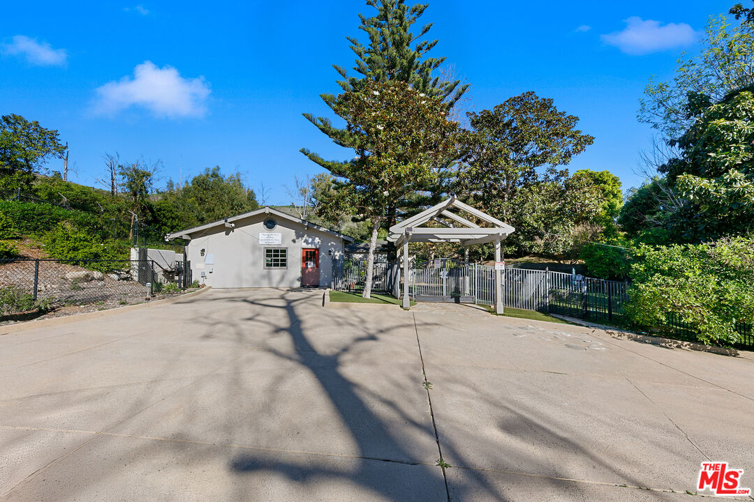 6070 Ramirez Canyon Road Malibu, CA 90265 - Photo 6 of 42 a white house with a tree in the background