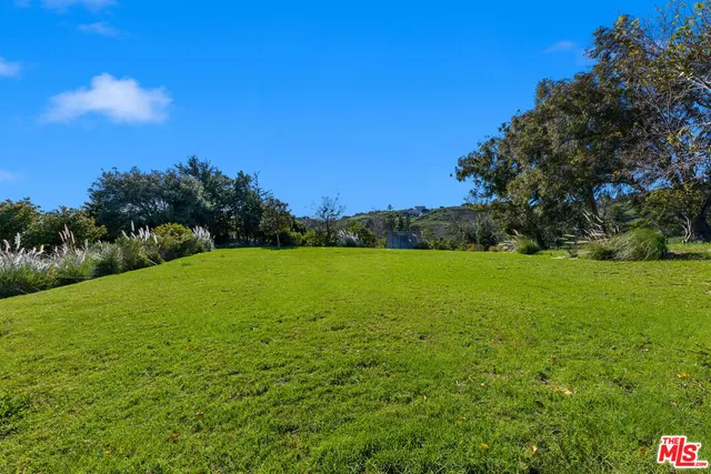 a backyard of a house with lots of green space