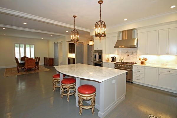 168 Marked Tree Road Needham, MA 02492 - Photo 8 of 19 a open kitchen with stainless steel appliances granite countertop a stove a refrigerator a kitchen island a dining table and chairs with wooden floor