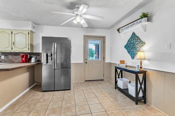 a kitchen with a refrigerator a sink and cabinets