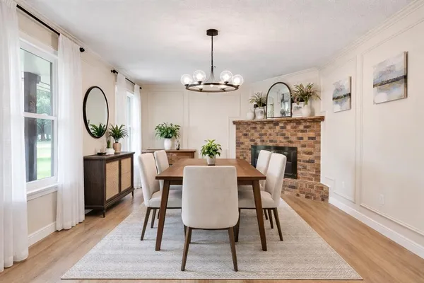 a dining room with furniture a chandelier and wooden floor