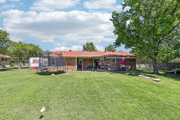a front view of house with yard and trees