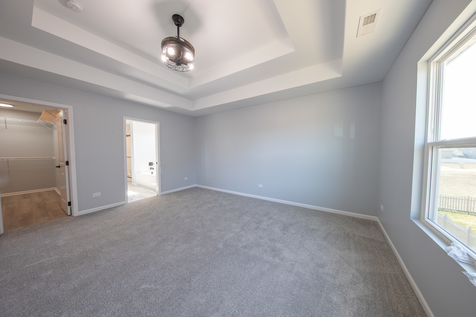 24372 Liberty Street Crete, IL 60417 - Photo 9 of 15 an empty room with windows and chandelier fan