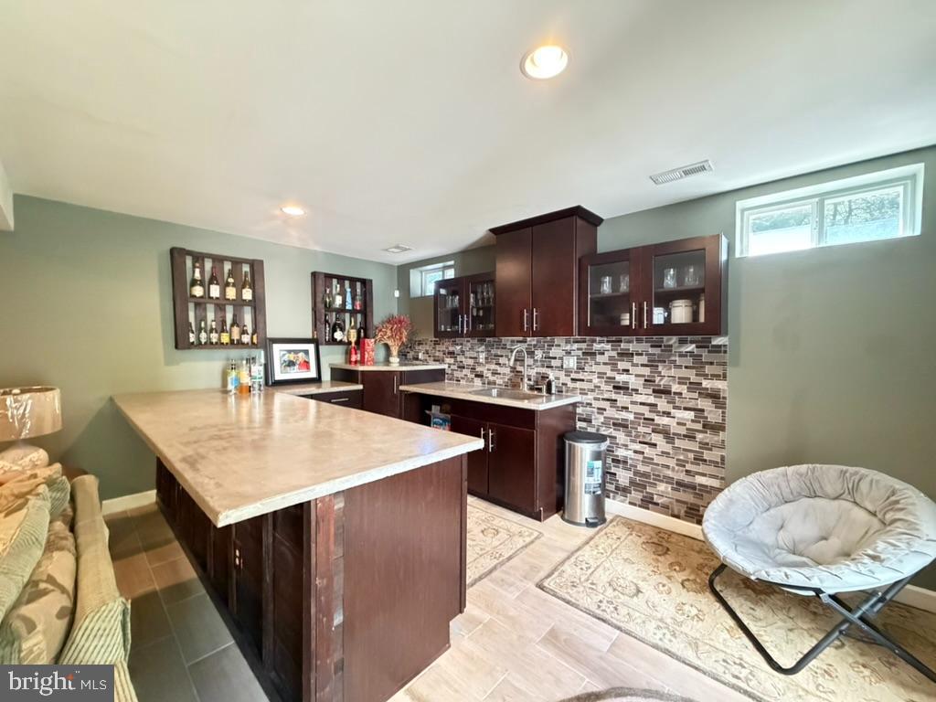 9804 Anvil Court Perry Hall, MD 21128 - Photo 20 of 21 a living room with stainless steel appliances kitchen island granite countertop a sink and a wooden cabinets