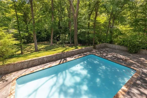 a view of a backyard with swimming pool