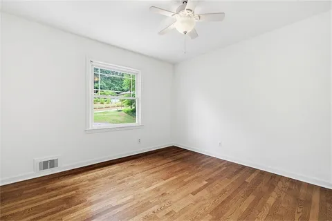 an empty room with windows and closet
