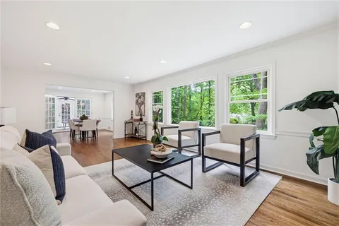 a kitchen with granite countertop kitchen island wooden cabinets a stove a sink and stainless steel appliances
