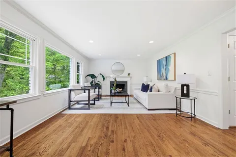 a kitchen with stainless steel appliances granite countertop a refrigerator a stove a sink dishwasher and a refrigerator with wooden floor
