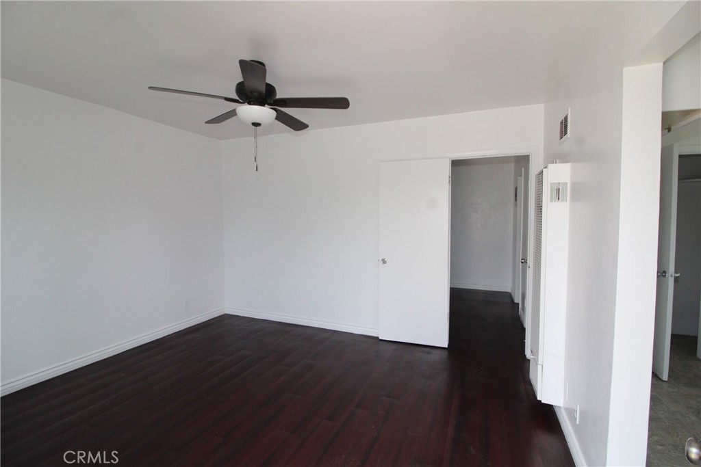 4954 Tweedy Boulevard, Unit F South Gate, CA 90280 - Photo 3 of 12 a view of a room with wooden floor and fan