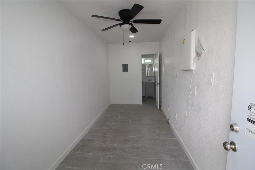 4954 Tweedy Boulevard, Unit F South Gate, CA 90280 - Photo 7 of 12 a view of a hallway with a chandelier fan
