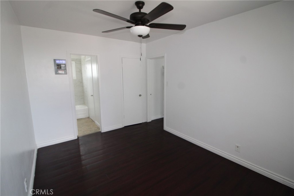 4954 Tweedy Boulevard, Unit F South Gate, CA 90280 - Photo 9 of 12 an empty room with wooden floor a ceiling fan and closet area