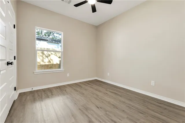 a kitchen with granite countertop a sink a stove and cabinets