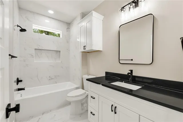 an empty room with a window and a ceiling fan