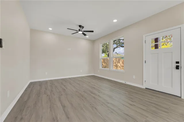 wooden floor in an empty room with a window
