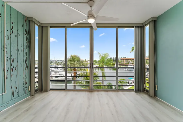 a view of a patio with a dining table and chairs with wooden floor