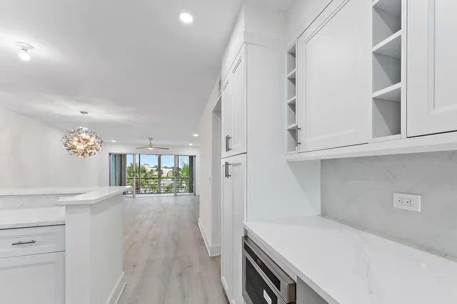 a kitchen with a white island cabinets and appliances